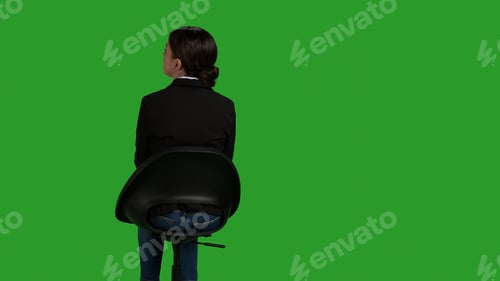 Preview: Back view of corporate worker sitting on chair and waiting on camera