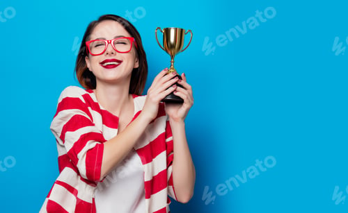 Preview: young smiling woman with cup trophy