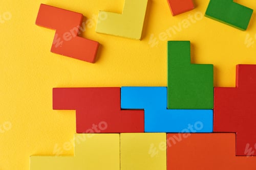 Preview: Different wooden blocks on yellow background. Concept of logical thinking and education