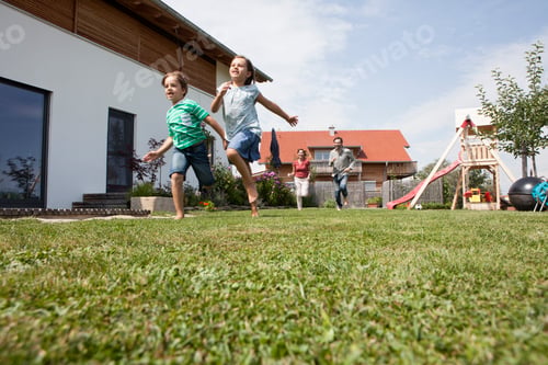 Preview: Carefree family running in garden