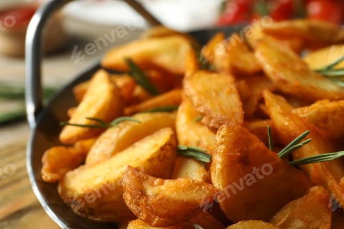 Preview: Metal dish with baked potatoes and rosemary, closeup