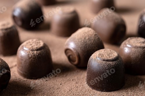 Preview: Chocolate bonbons and cocoa powder background