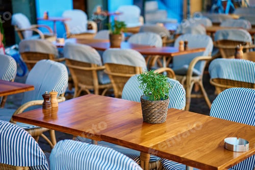 Preview: Street view on empty restaurant tables outdoors in morning