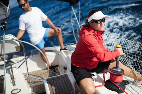 Preview: Attractive strong woman sailing with her boat