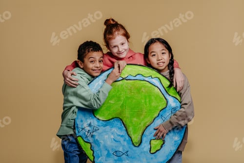Preview: Portrait of three children with model of Earth, studio shoot. Concept of diversity in friendship.