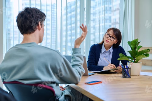 Preview: Guy student at therapy meeting with psychologist, mentor in college office