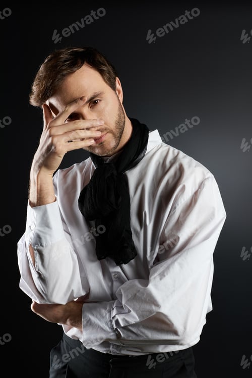 Preview: A stylish dandy contemplates life with a thoughtful expression in a minimalist studio setting