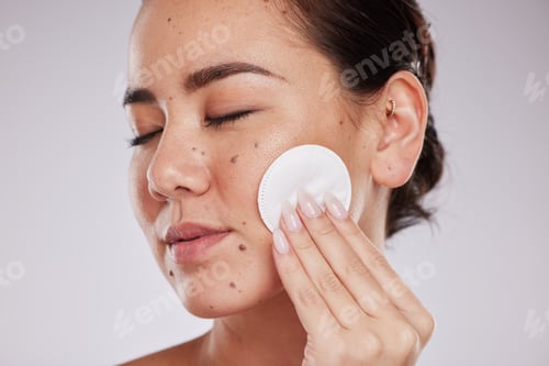 Preview: Skincare cotton, face and woman with eyes closed in studio isolated on gray background. Makeup hygi