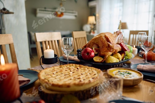 Preview: Dining table with roast turkey for Thanksgiving meal at home.