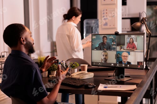 Preview: Project manager speaking to remote colleagues on videoconference