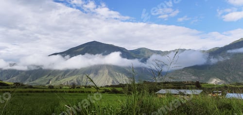 Preview: Stunning view of a majestic mountain surrounded by a blanket of white clouds
