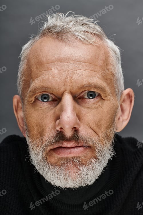 Preview: portrait of handsome bearded mature male model in fashionable black turtleneck looking at camera