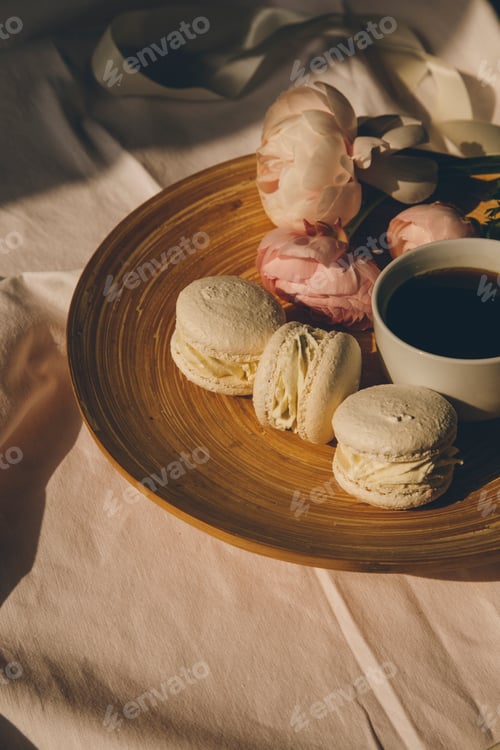 Preview: top view of cup of coffee with macarons and flowers