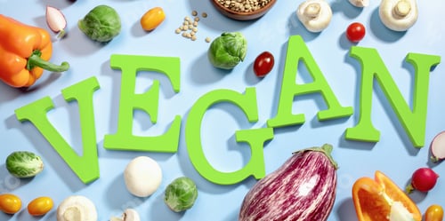 Preview: word VEGAN in green letters on blue, surrounded by fresh fruits, vegetables, and a bowl of lentils
