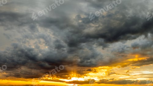 Preview: Beautiful sunset sky scenery. Bright colorful orange and yellow clouds on horizon