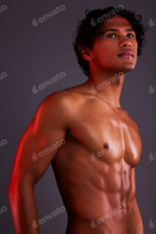 Preview: Light, strong and man chest in a studio with art lighting and thinking with muscles and fitness. Fo