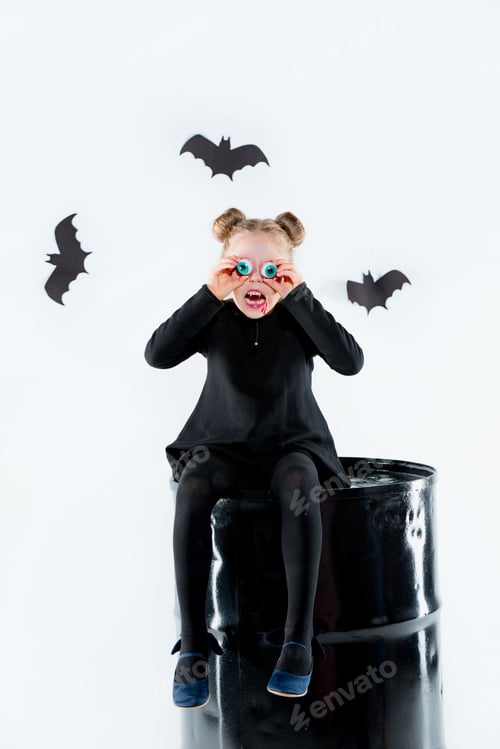 Preview: Little Girl Witch In Black Dress Over Magical Accessories. Halloween, The Studio Evening.