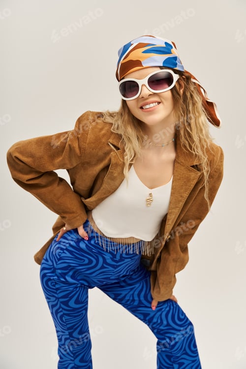 Preview: Stylish young woman showcasing vibrant fashion against a modern grey backdrop