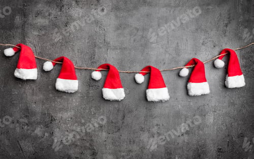 Preview: Christmas Santa hats on rustic background with copy space