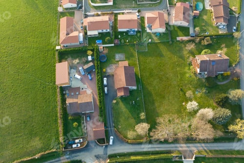 Preview: Aerial view of residential houses in green suburban rural area