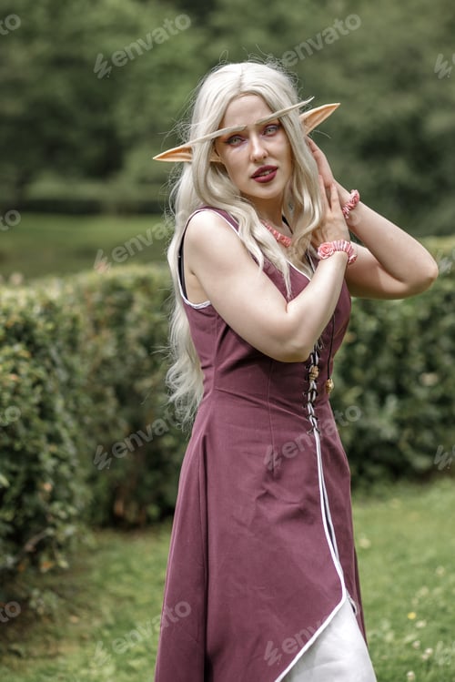 Preview: Young elf girl with blond long hair. Beautiful medieval elven princess in a burgundy dress