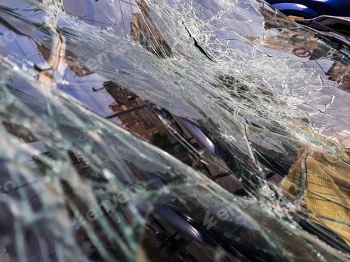 Preview: Broken windshield of abandoned and destroyed car, with broken glass.