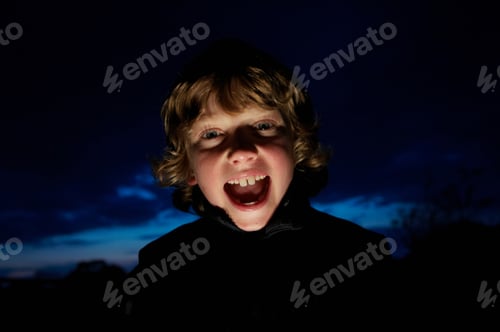 Preview: Boy making faces with flashlight
