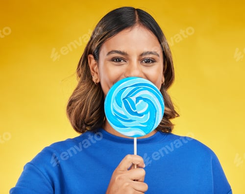 Preview: Lollipop, candy and portrait of woman with sweet dessert with sugar isolated in a studio yellow bac