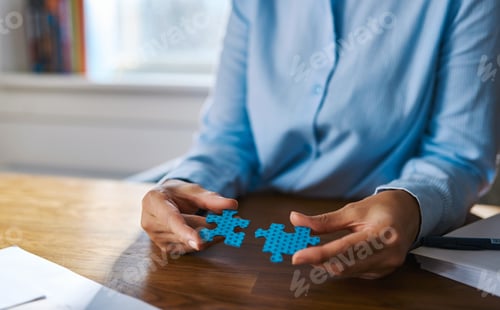 Preview: Close up of hands assembling two puzzle pieces