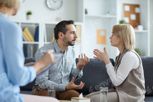 Man and Woman Discussing Issues in Therapy Session