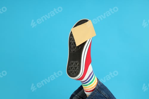 Preview: Blank sticker pasted on red sneaker on blue background
