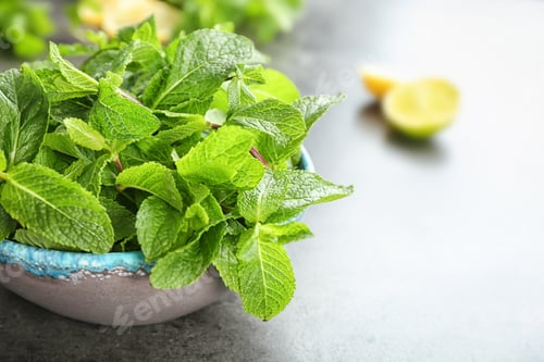 Preview: Bowl with fresh aromatic mint on table