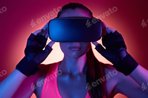 Preview: Young woman wearing virtual reality glasses against colorful background