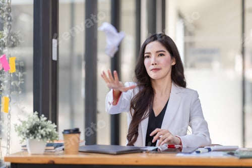 Preview: tired business Asian woman angry and bored from sitting at a desk for a long time in workplace offic