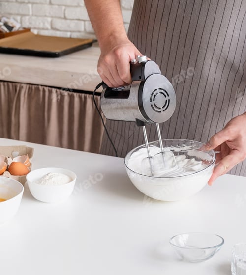 Preview: man wearing apron cooking tiramisu at kitchen