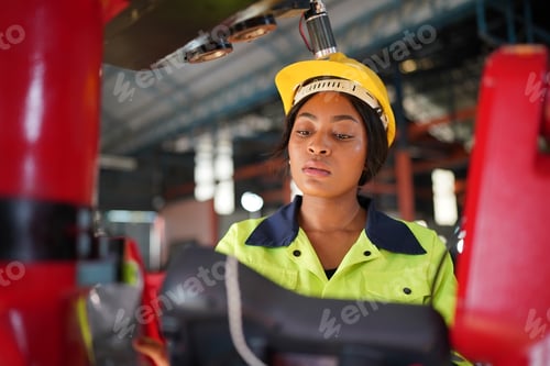 Preview: Robotics engineer working on maintenance of robotic arm in factory warehouse. Business technology.