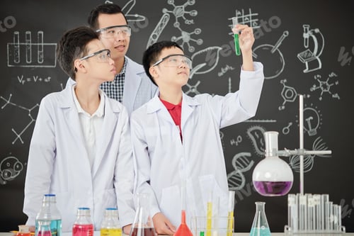 Preview: Proud schoolboy showing test-tube