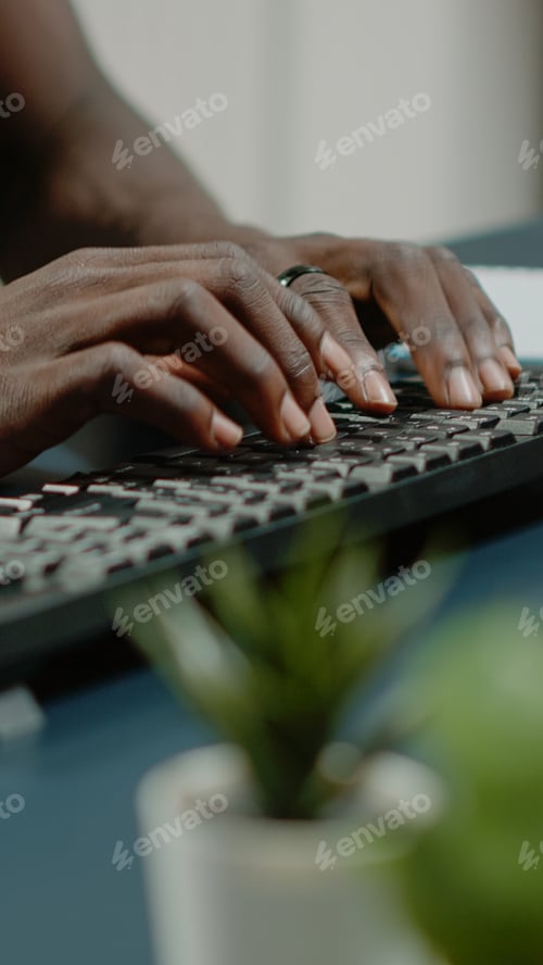 Preview: Close up of hands using computer keyboard and listening to music