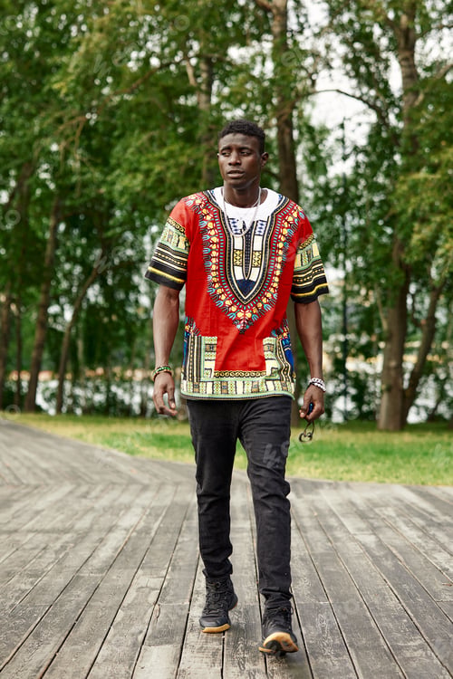 Preview: A black man walks in the park, an attractive black man, smiling, walks through the city park, rest