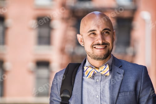Preview: Businessman walking outdoors, smiling