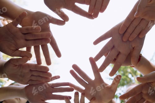 Preview: they hold their hands together symbolizing friendship, unity, and peace. , against the sky