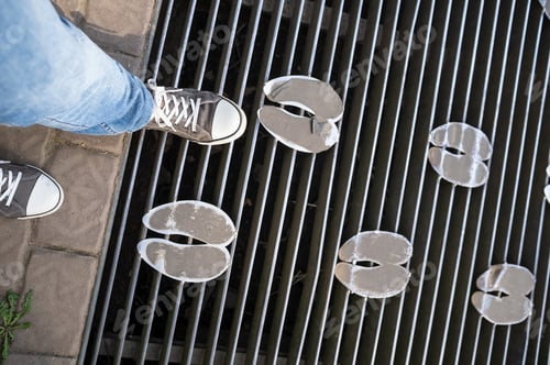 Preview: man legs on mesh bridge with metal footprints on a walkway in a petting zoo
