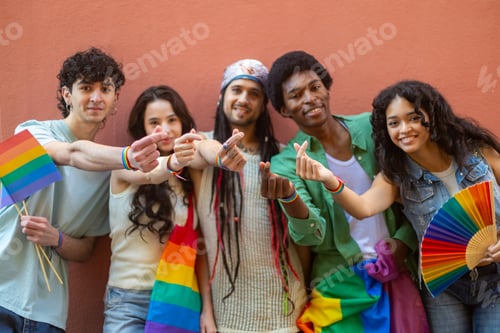 Preview: Young activists showing rainbow bracelets and flags celebrating gay pride
