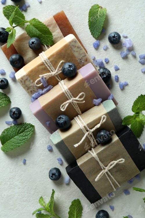 Preview: Different natural soap for skin care on white textured table