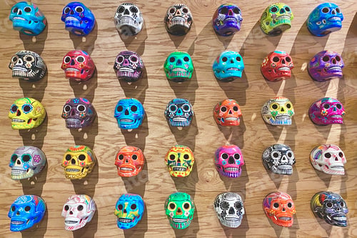 Preview: Colorful flatlay background of painted Mexican skulls for the day of the dead Dia de Los Muertos