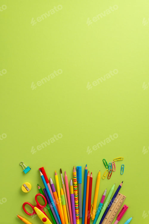Preview: Back-to-school essentials: Vertical top view of stationery fan with color pencils, pens, scissors