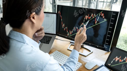 Preview: Businesswoman investor having planning and analyzing graph data with display screen the data