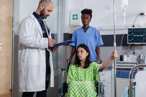 Preview: Man doctor writing healthcare expertise on clipboard working hospital ward