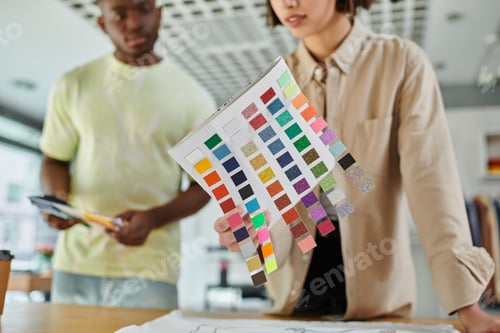Preview: cropped view of woman holding color palette near african american designer in print studio
