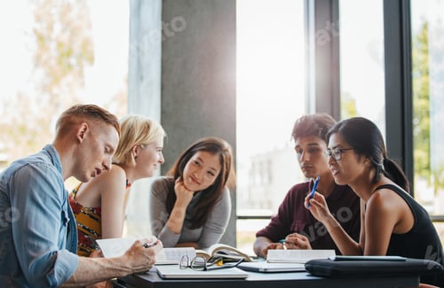 Preview: Group of students doing school assignment in library